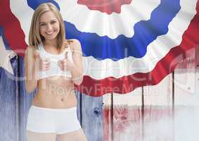 Smiling blond woman thumbs up against american flag