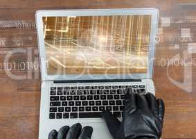 hands with gloves using a laptop in a wood table