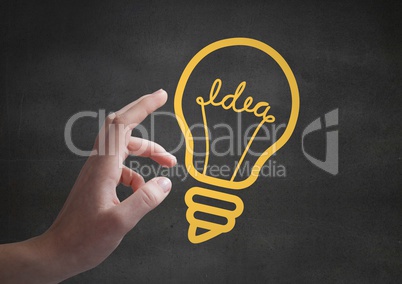 Hand pointing at 3D yellow lightbulb graphics against grey wall