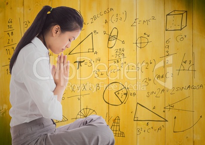 Business woman meditating against 3D yellow wood panel and math graphic
