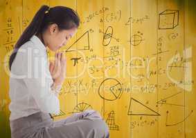 Business woman meditating against 3D yellow wood panel and math graphic