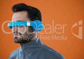 Man in virtual reality headset against orange background
