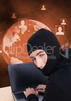 Hacker using a laptop looking at the camera