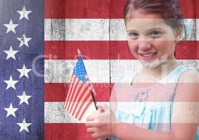 Little girl holding american flag against american flag