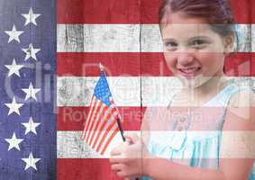 Little girl holding american flag against american flag