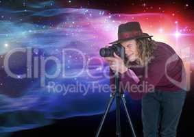 Photographer taking picture in front of colored lights background