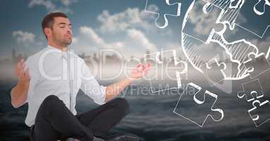 Business man meditating against 3d blurry skyline and water with white jigsaw doodle