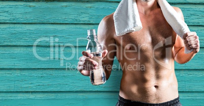 Man standing against a blue wooden background after exercise