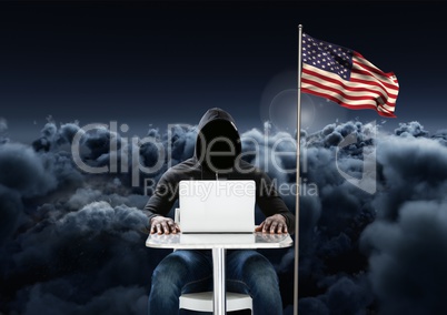 Hacker working on laptop close to the american flag with 3D cloudy background