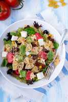 Mediterranean Farfalle salad with dry tomatoes and pine cores