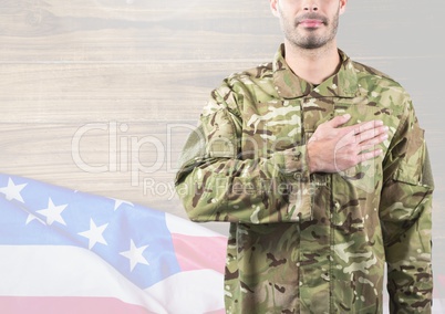 Part of a soldier putting his hand on heart against 3d independence day background