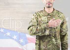 Part of a soldier putting his hand on heart against 3d independence day background