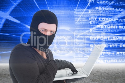 Hacker using a white laptop on blue interface