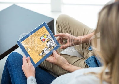 couple with tablet with a 3d design for the new house (yellow, red and blue)