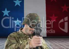 Soldier aiming the lens in front of french flag