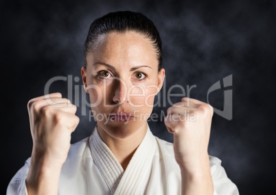 Woman in karate suit against mist