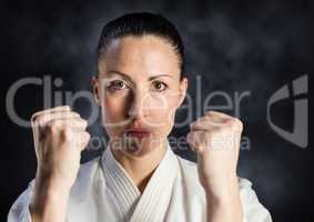 Woman in karate suit against mist