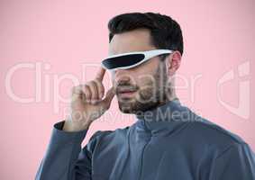 Man in virtual reality headset against pink background