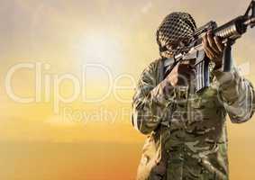 Black soldier holding a firearm in desert