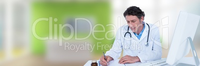 Doctor writing at desk against green blurred office