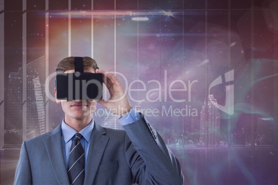 Man in VR headset looking against galaxy and city background