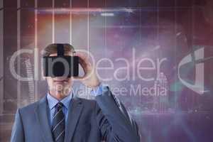 Man in VR headset looking against galaxy and city background