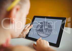 Girl using a tablet with travel icon on the screen