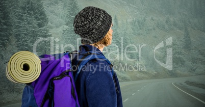 Millennial backpacker looking down misty road