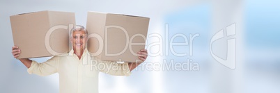 Man holding boxes in front of blurred background and copy space