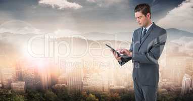 businessman with tablet in cityscape
