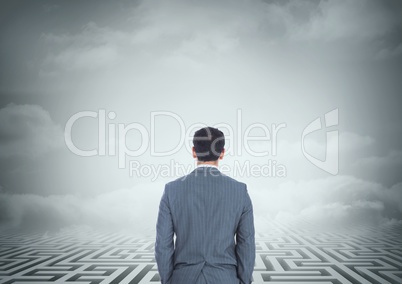 Man looking at a maze with clouds 3d