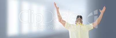 Man with arms open in air in front of blurred background and copy space