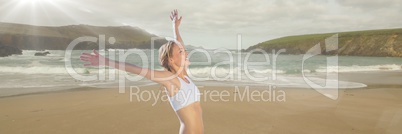 Woman in underwear celebrating on beach with blur