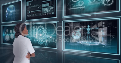 Woman doctor looking at 3d medical interfaces against background with flares