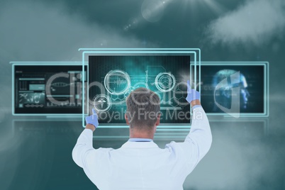 Man doctor interacting with 3d medical interfaces against sky with clouds