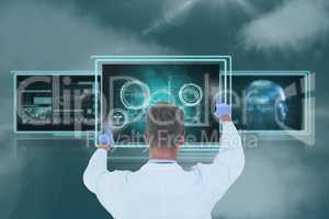 Man doctor interacting with 3d medical interfaces against sky with clouds