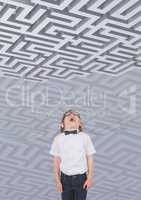 Boy looking up to a maze against background with 3d mazes