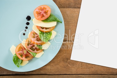 Blank card on wooden desk with food and copy space on a paper