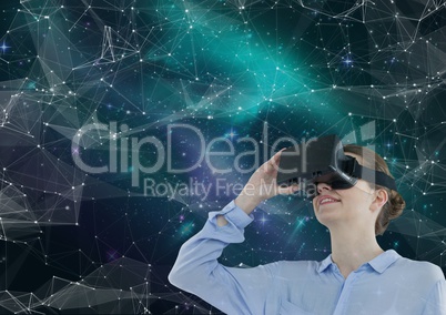 Woman in VR headset looking up against green and purple space background with interface