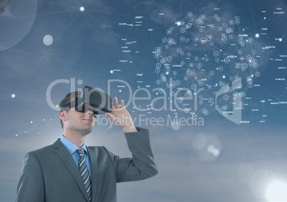 Man in VR headset looking to an interface against blue sky with flares