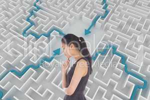 Woman thinking against background with a maze 3d