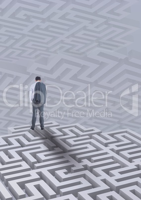 Man standing on a 3D maze against background with mazes
