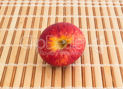 Red apple on strips of wood, seen from above