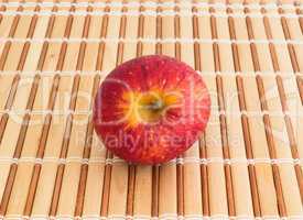 Red apple on strips of wood, seen from above