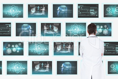 Man doctor looking at 3d medical interfaces against white background