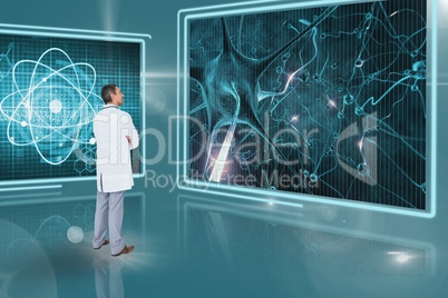 Man doctor looking at 3d medical interfaces against blue background with flares