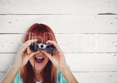 Surprised woman looking through binoculars against white copy space background