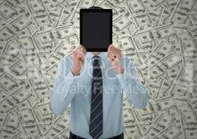 Business man holding tablet over face against money backdrop