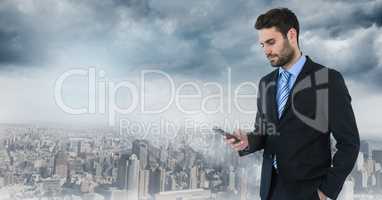 businessman with phone in cityscape