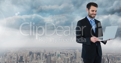 businessman with laptop in cityscape businessman with laptop in cityscape